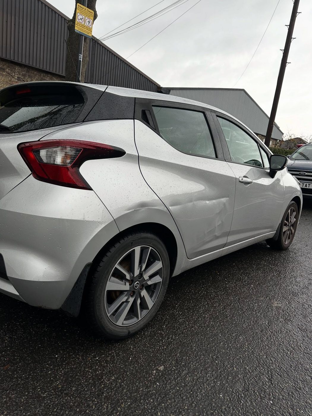 Nissan Micra rear quarter panel with a visible dent, before repair