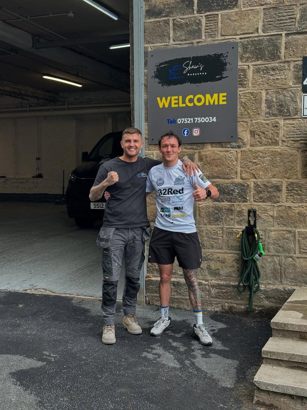 Shaw's Bodyshop workshop entrance in Guiseley, with Joey outside the unit